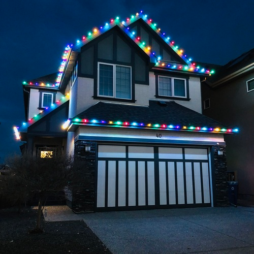medium sized, two storey home with holiday lighting installation