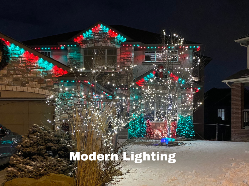 Modern holiday lighting display on a two-storey house in Calgary, featuring red, green, and white LED lights with bright tree wraps and architectural accents installed by Knight Illumination.