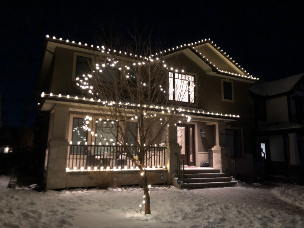 house decorated in traditional holiday lighting style